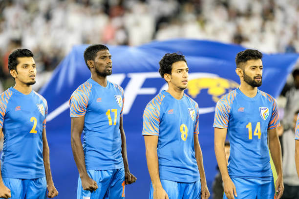 Football rank of India: Indian players singing the national anthem before a World Cup qualifying match.
