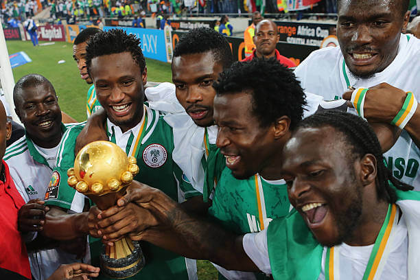 African National Football Teams: John Mikel Obi and Victor Moses lead celebrations with teammates with the trophy after winning the 2013 AFCON.