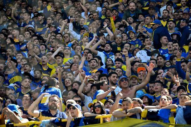 Top derbies in football: Fans of Boca Junior cheers for their team during a Superclásico match between Boca Juniors and River Plate at La Bombonera stadium.