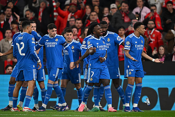 Benfica vs Real Madrid Review: Vinicius Junior celebrates his goal with his teammates during the UEFA Champions League 2025/26 Play-offs First Leg match between Benfica and Real Madrid at Estádio da Luz on February 17, 2026.