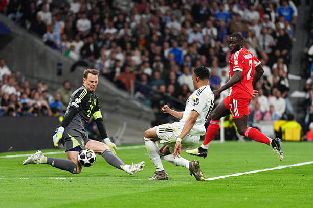 Real Madrid vs Bayern Munich Review: Manuel Neuer saves a shot from Kylian Mbappe during the UEFA Champions League 2025/26 Quarter-Final First Leg match between Real Madrid and Bayern Munich at the Santiago Bernabeu on April 07, 2026.