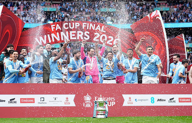 Chelsea vs Manchester City Review: Manchester City players celebrate with the FA Cup trophy following their victory over Chelsea at Wembley on May 16, 2026.